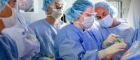 Orthopedic surgeon instructing medical student in the operating room